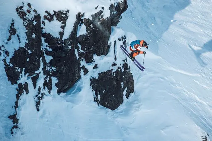 Vesselin dropping a cliff on freeride skis